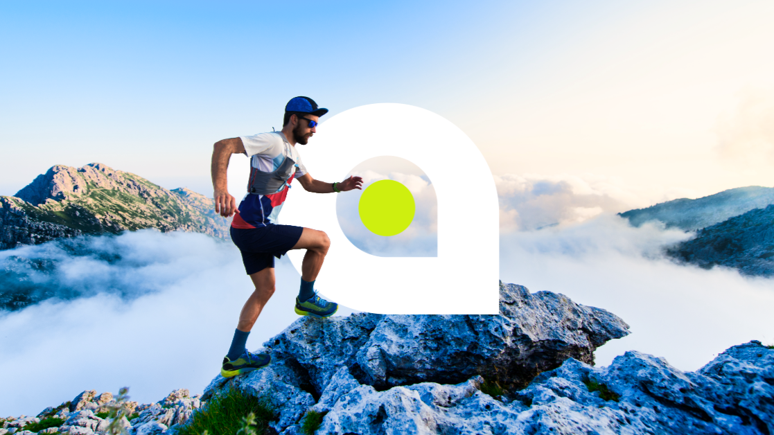Man running on a mountain with a scenic background